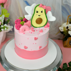 Pink cake with cute avocado decoration